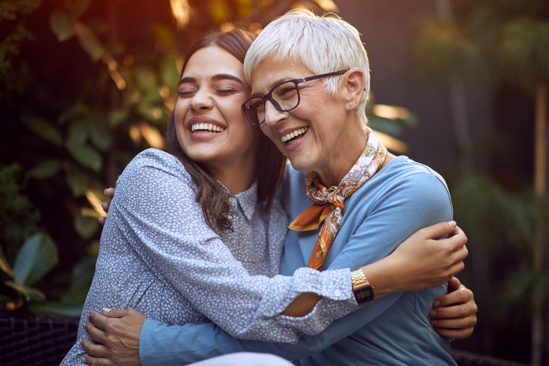 Happy daughter embracing her smiling mother.