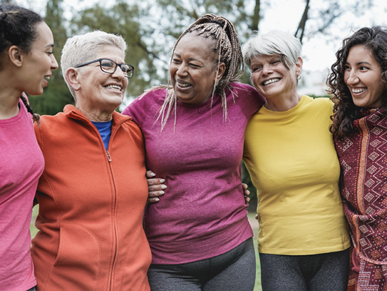 Group of women with arms wrapped around each other and smiling